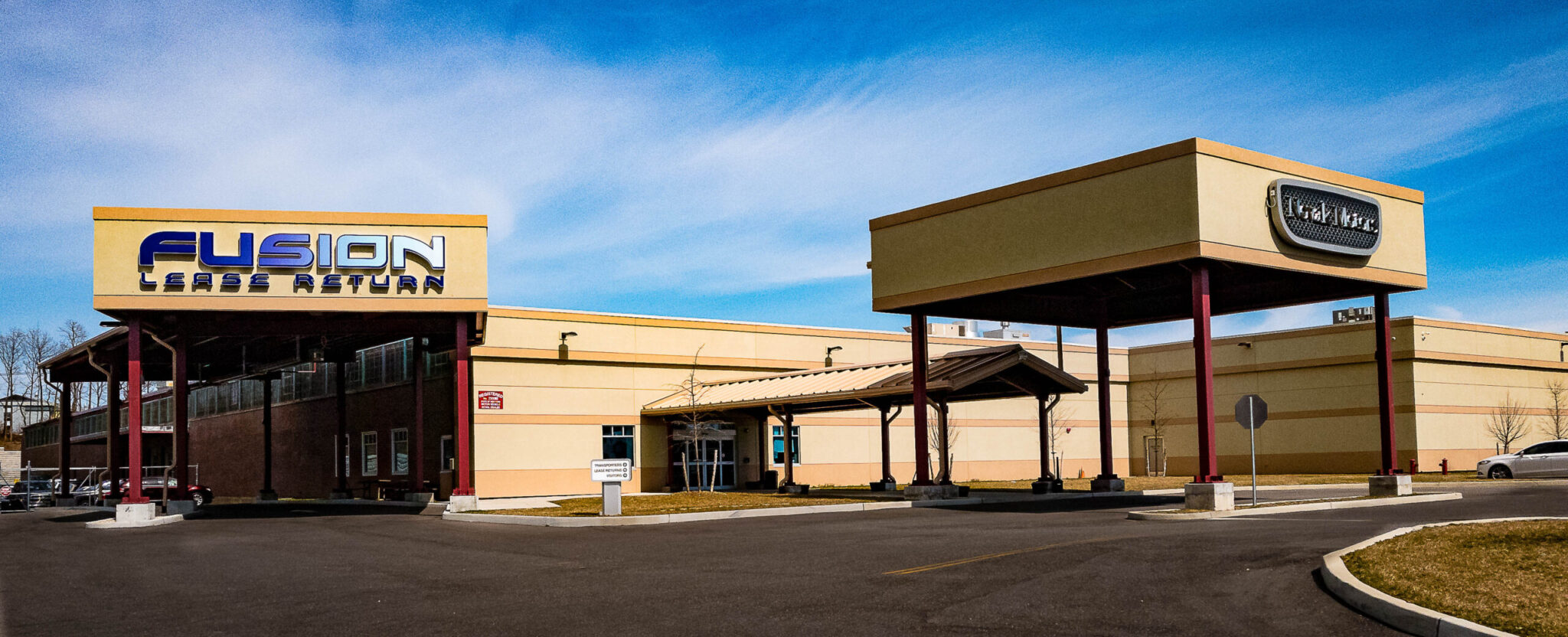 Exterior of Fusion Lease Return and Novak Motors facility in Farmingdale, New York, showcasing the 120,000-square-foot expansion that increased Fusion Auto Finance’s capacity in 2016.